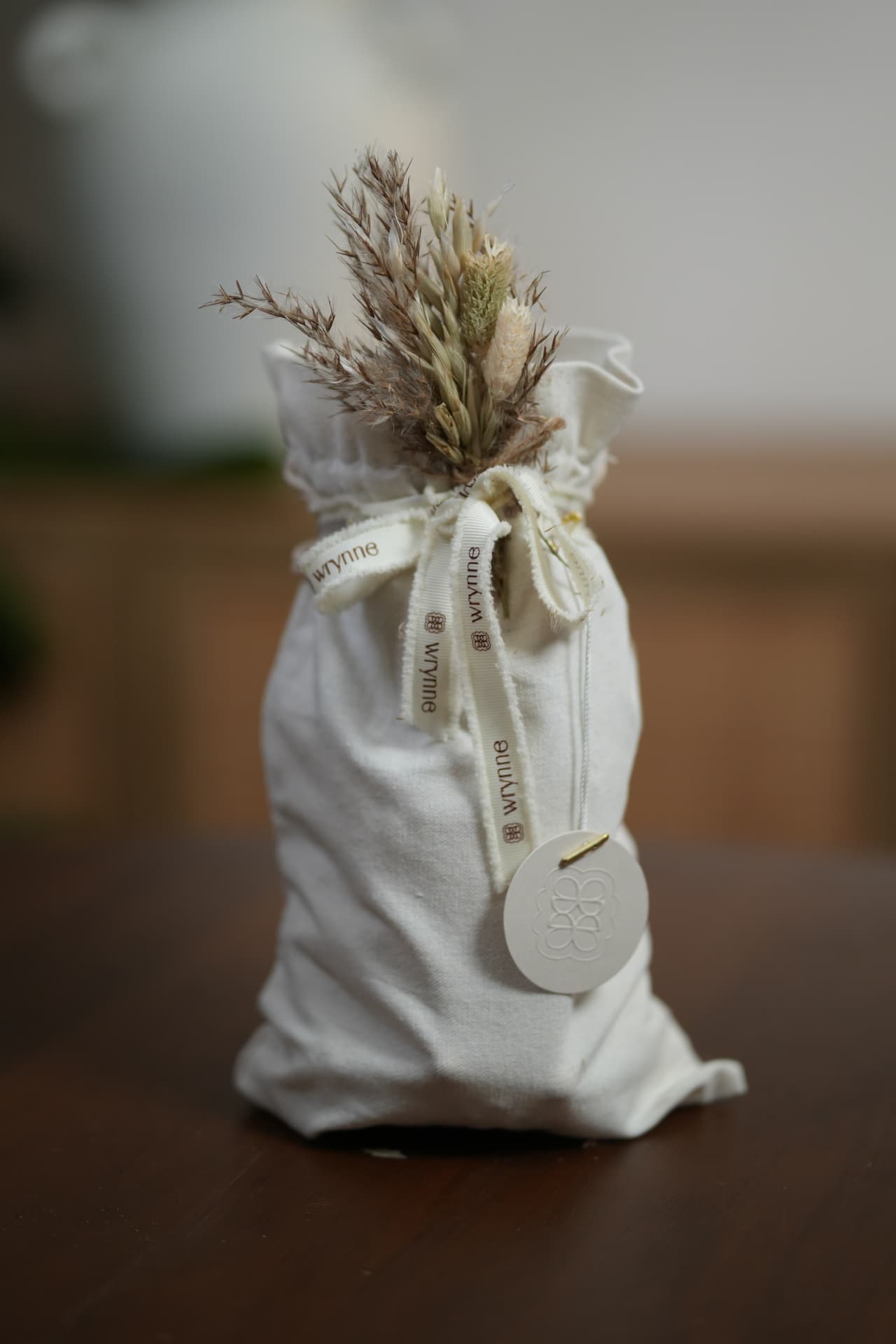 A fabric gift pouch with Wrynne finishing details